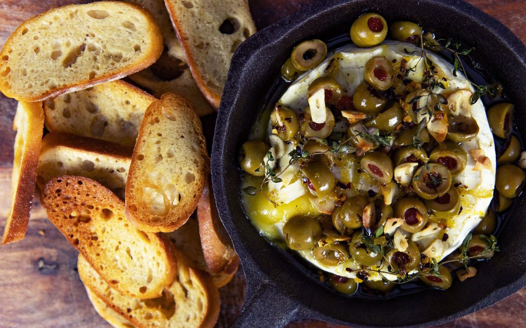 Stuffed olive baked brie with chilli honey dressing